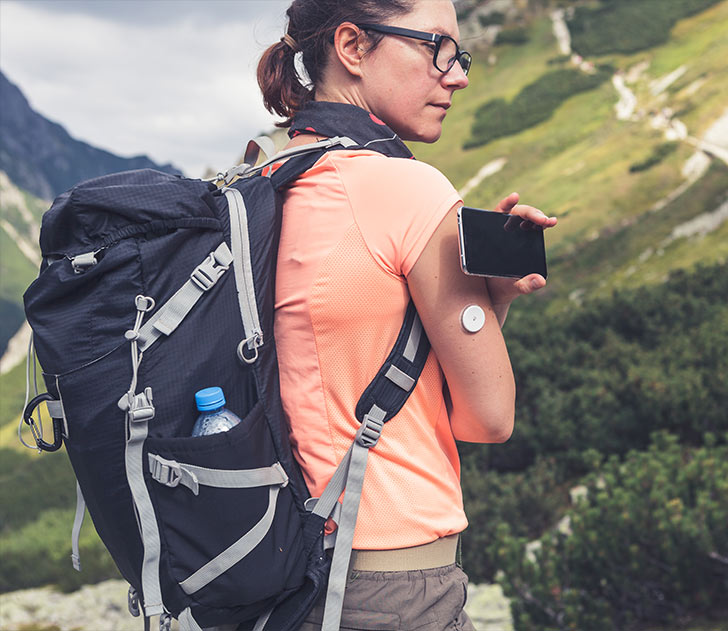 A woman with a backpack and cell phone